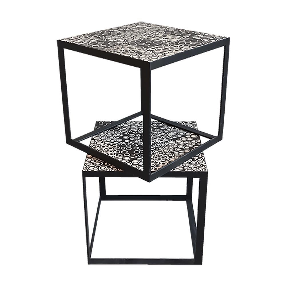 This compact accent table features a handcrafted tiled top—glossy handpainted tiles neatly set in bold black grout, sealed for easy cleaning and durability. The surface measures 54cm by 54cm and the table is 40cm high, its geometric mosaic surface