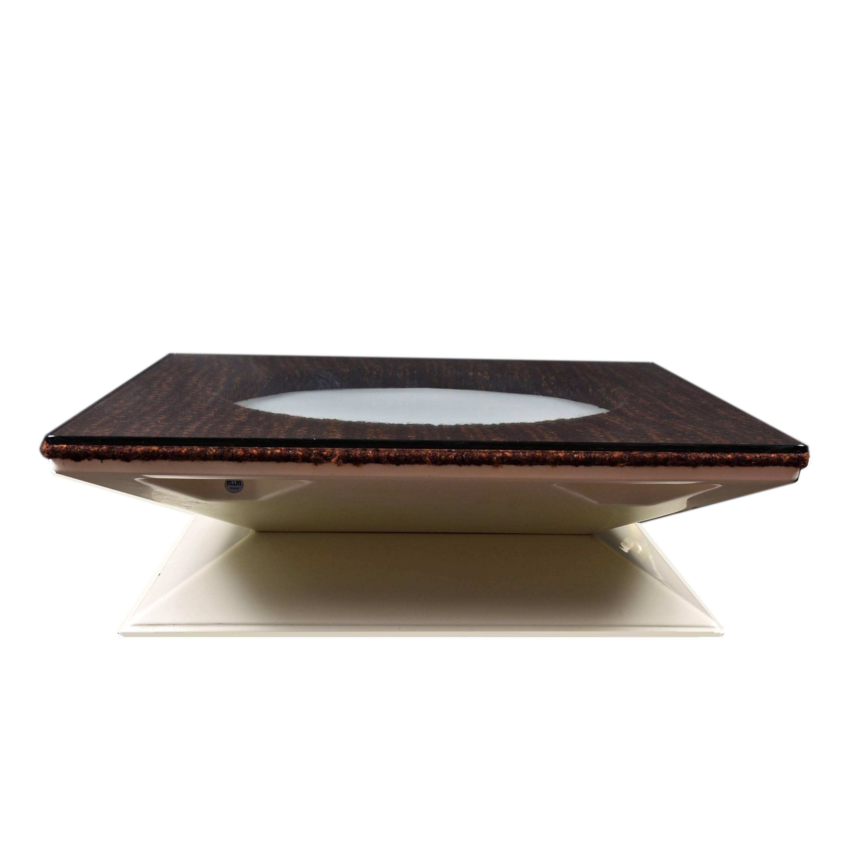 This coffee table was produced by M.I.M. Roma in the 1970s and has an illuminating circle in the center with bouclè.