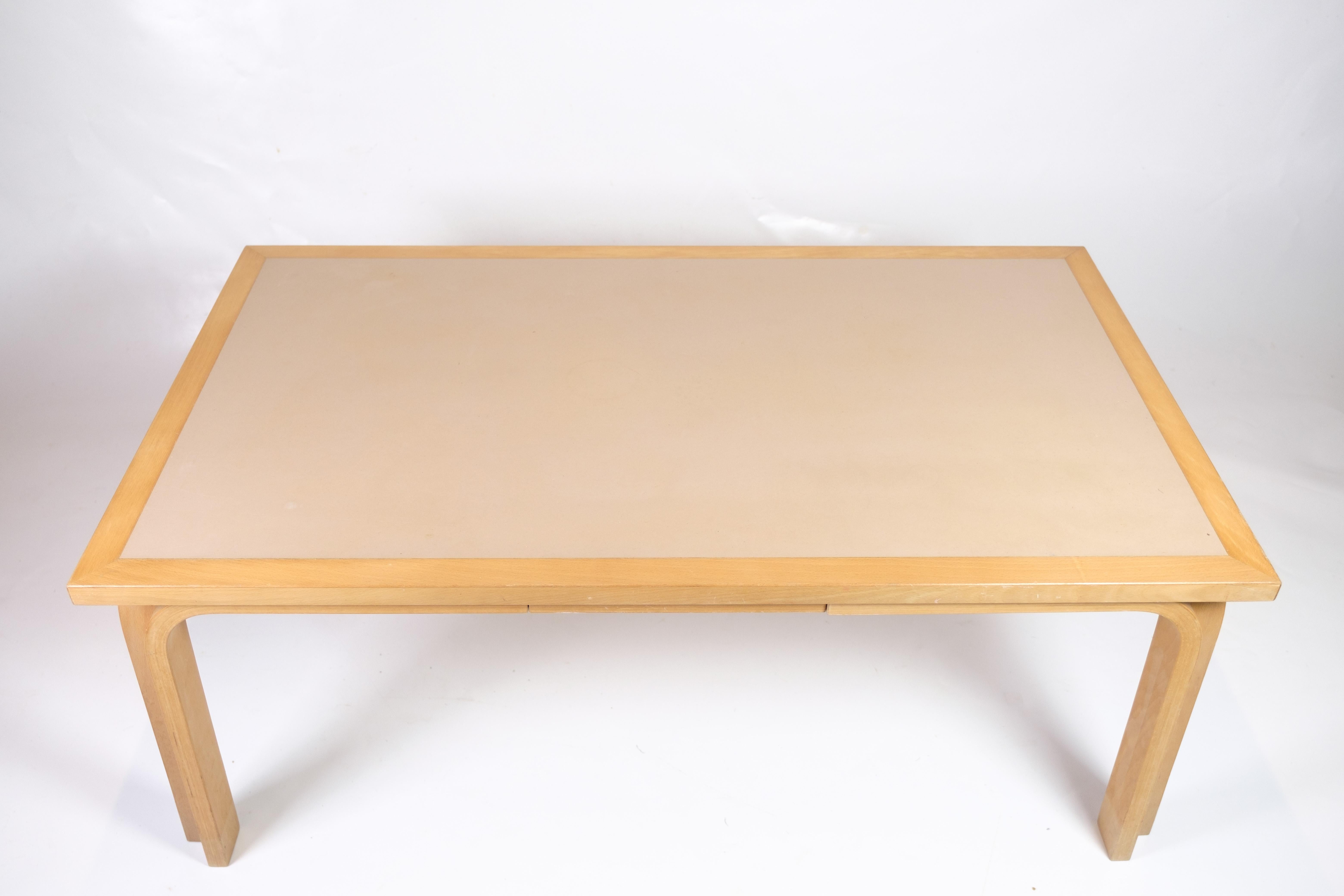 Coffee table made of beech wood with a linoleum surface, designed by Magnus Olesen. The table combines a solid frame in light beech wood with a practical linoleum surface, making it resistant to daily use. The curved corners and legs add a soft and