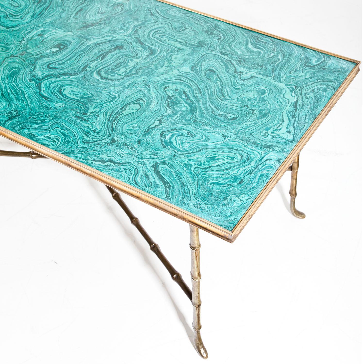 Coffee table standing on faux bamboo brass legs with x-shaped strutting and a beautiful malachite tabletop.