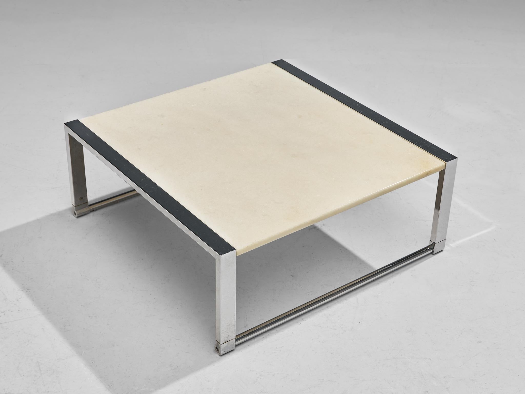 Coffee table, marble, chrome, Europe, 1980s. 

Exuding simplicity, this unassuming side table exudes an aura of pure elegance. Its design showcases a square, delicately marble tabletop, seamlessly integrated into an architectural structure.