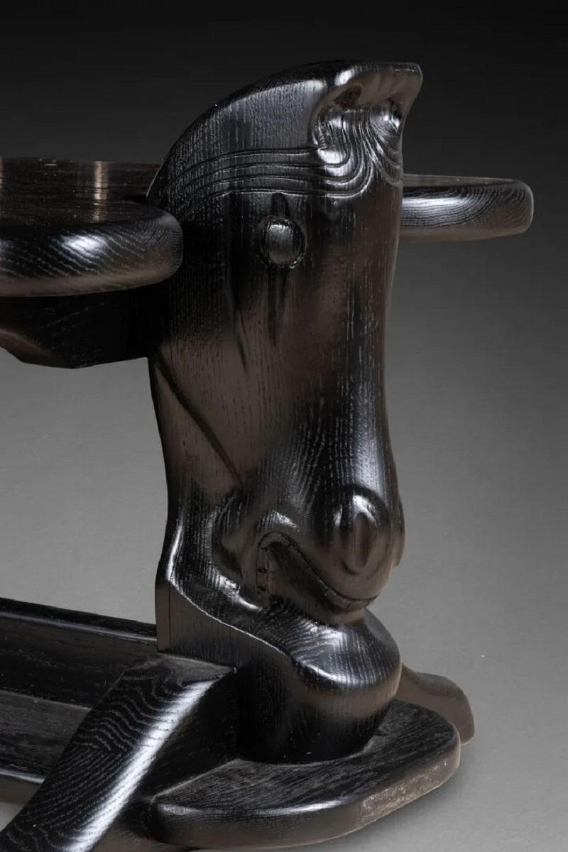 Carved COFFEE TABLE with rectangular top. The feet surmounted by horse heads circa 1970 For Sale