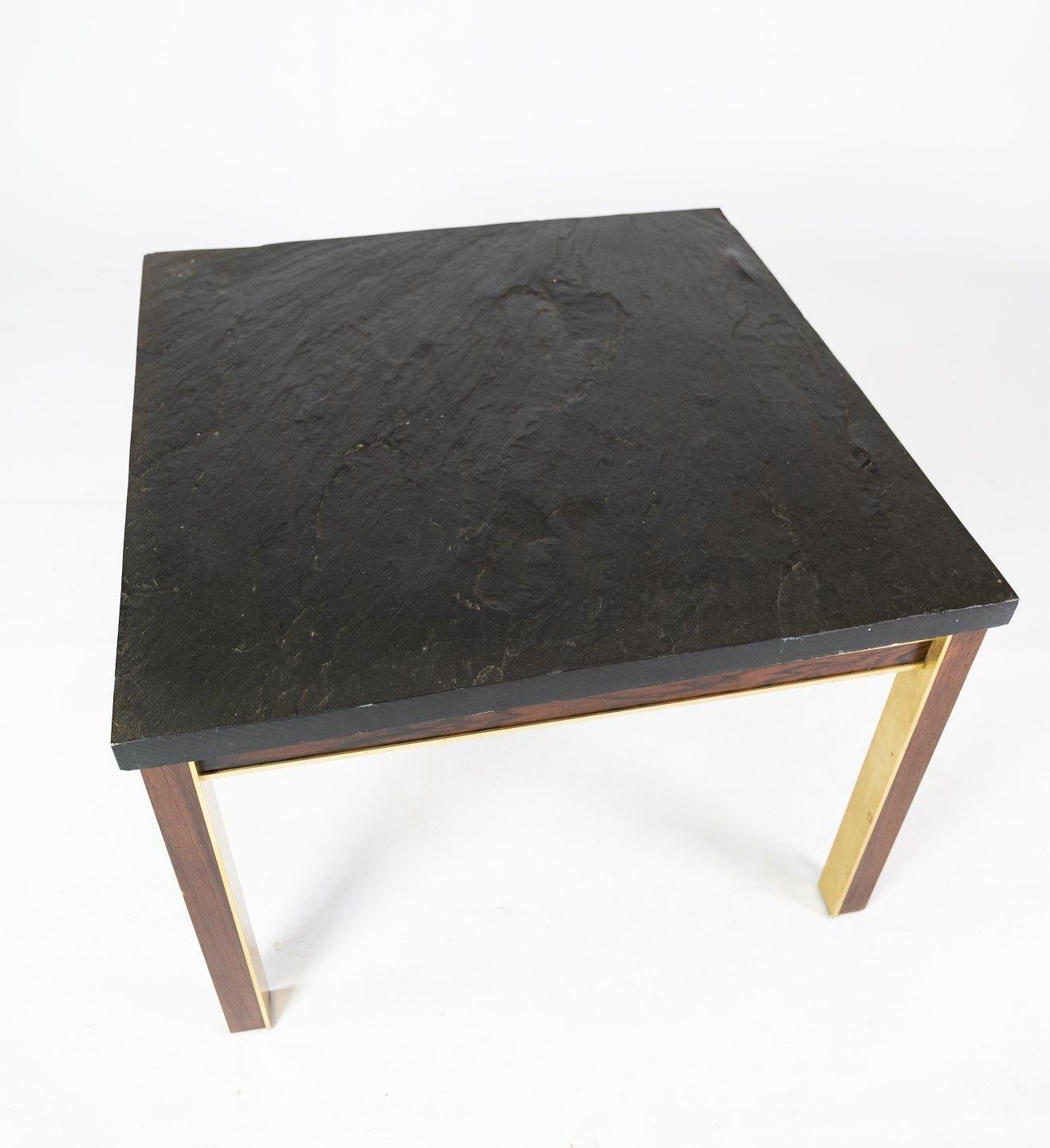 Coffee table with slate plate, frame of gilded metal and rosewood by Bendixen Design from the 1970s. The table is in great used condition.
  