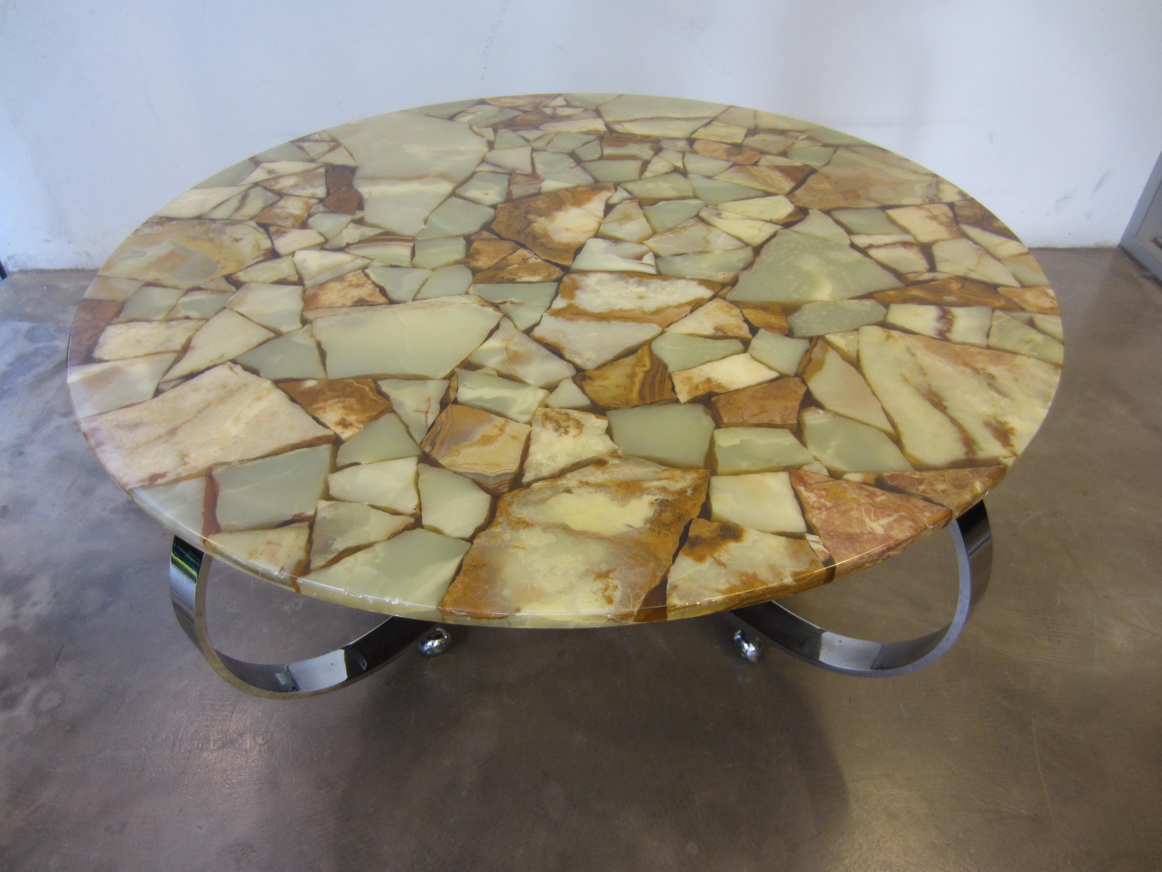 Unique coffee table with solid stone plate on chromed frame, steel legs have wheels. Table is a very exclusive appearance. Minor signs of wear on the frame and the leaf. 

Measurements: 
Diameter 120 cm. 
Height 52 cm.

 