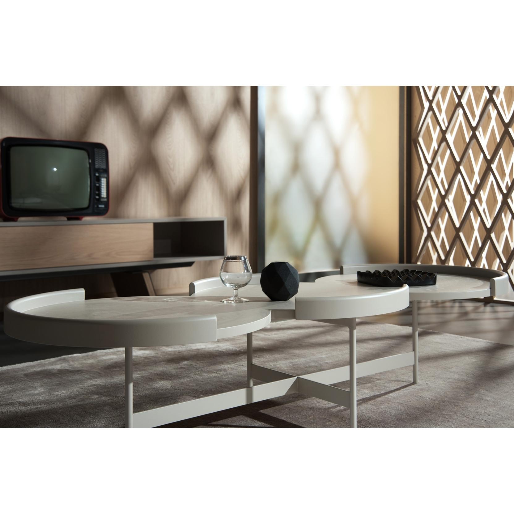 This coffee table is a modern and sophisticated piece of furniture, designed to complement contemporary living spaces. It features a sleek, minimalist design characterized by clean lines and a refined aesthetic. The table top is made of wood. Its