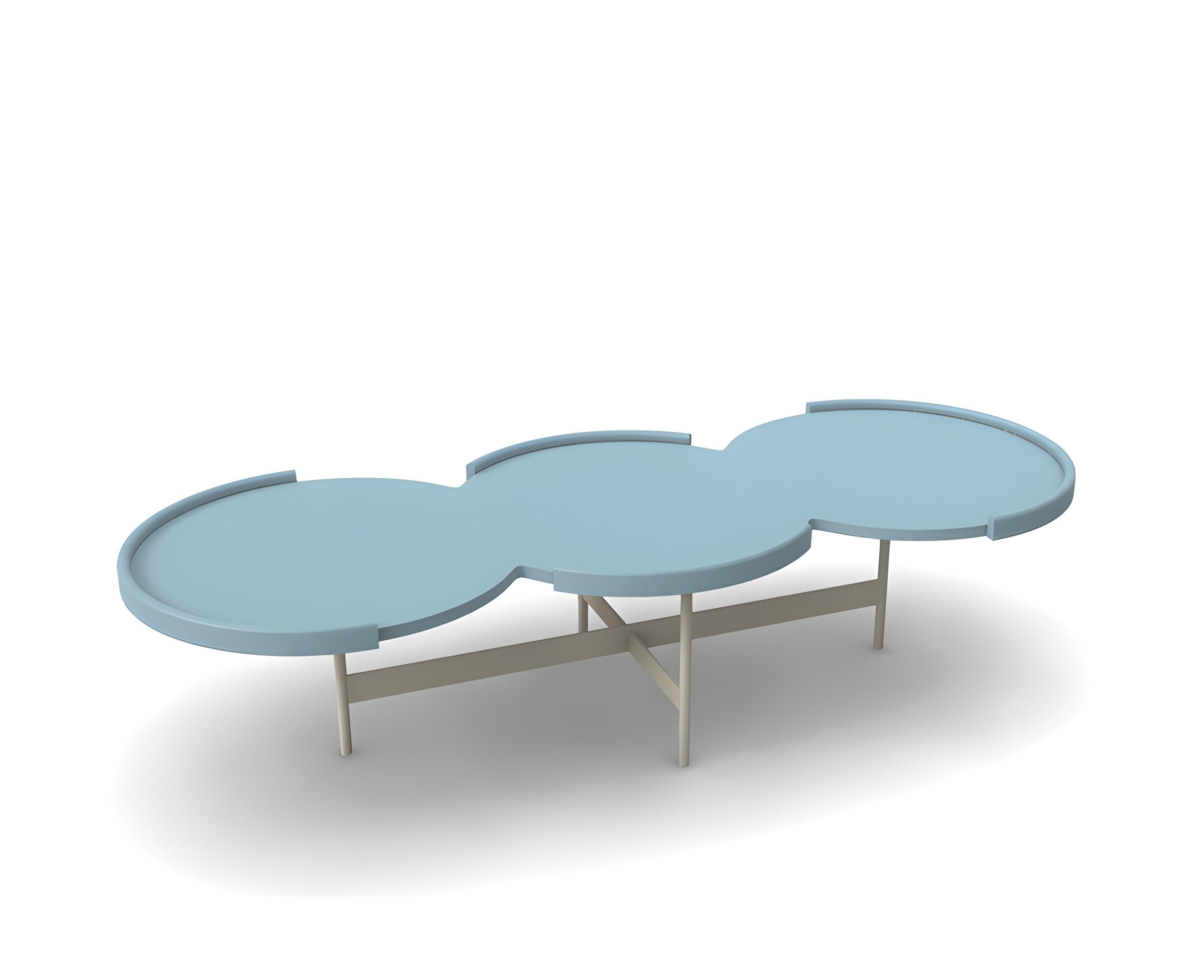 This coffee table is a modern and sophisticated piece of furniture, designed to complement contemporary living spaces. It features a sleek, minimalist design characterized by clean lines and a refined aesthetic. The table top is made of wood. Its