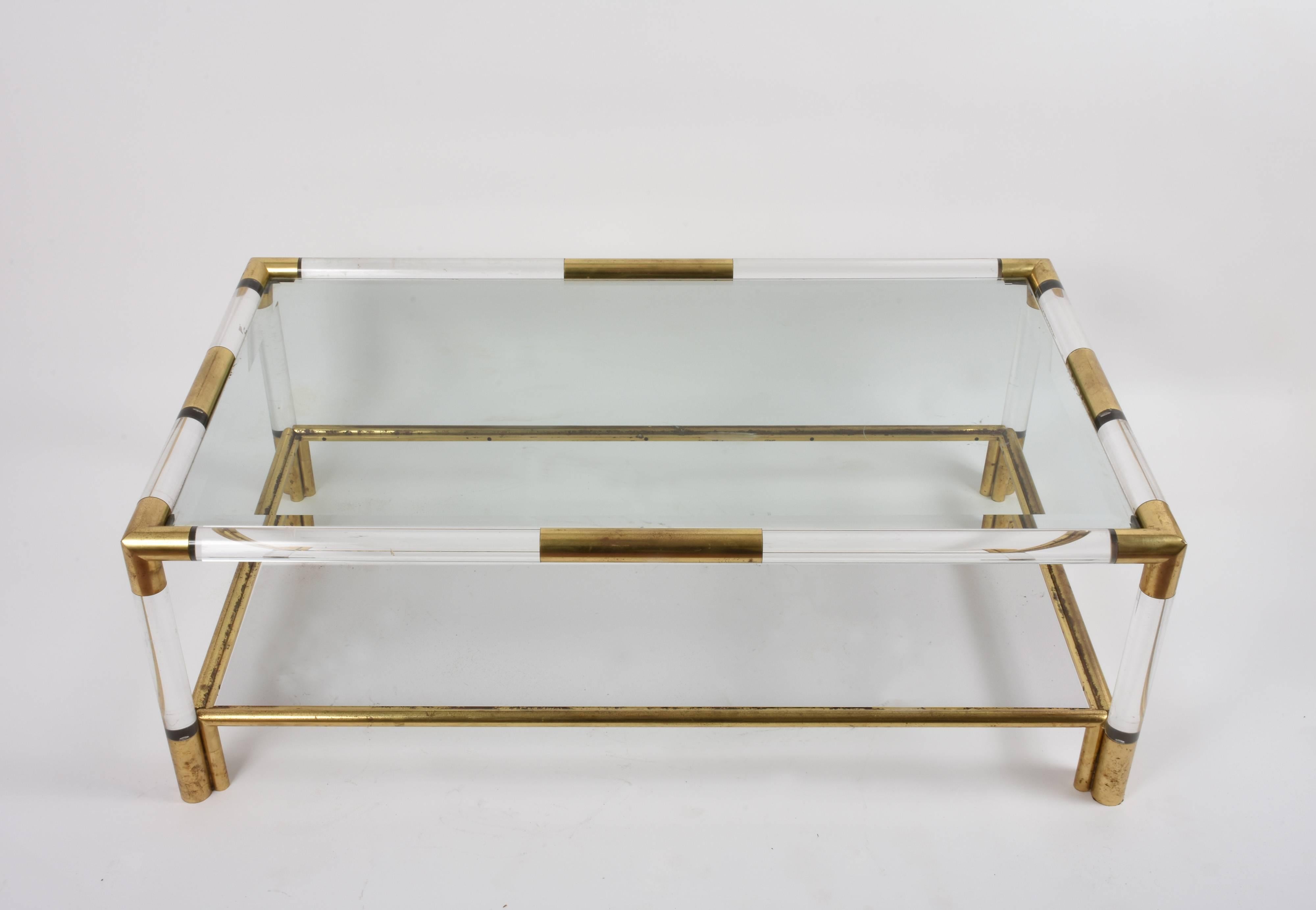 Coffee table with two vintage shelves in Lucite and brass. Ground glass top.