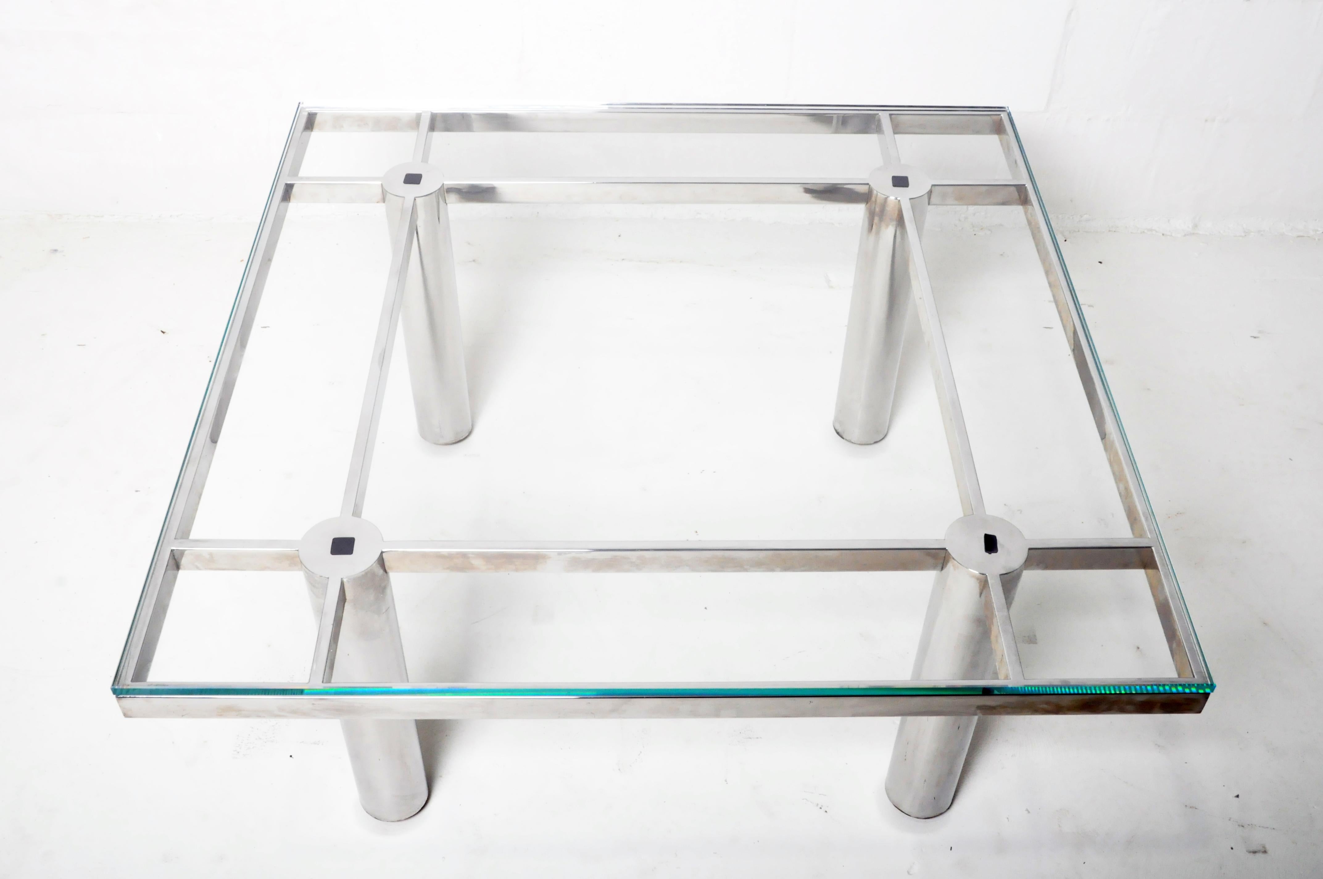This coffee table was made from vintage chrome legs and features a new glass top, c. 20th century. The table was made in Chicago and the glass top is new.
 