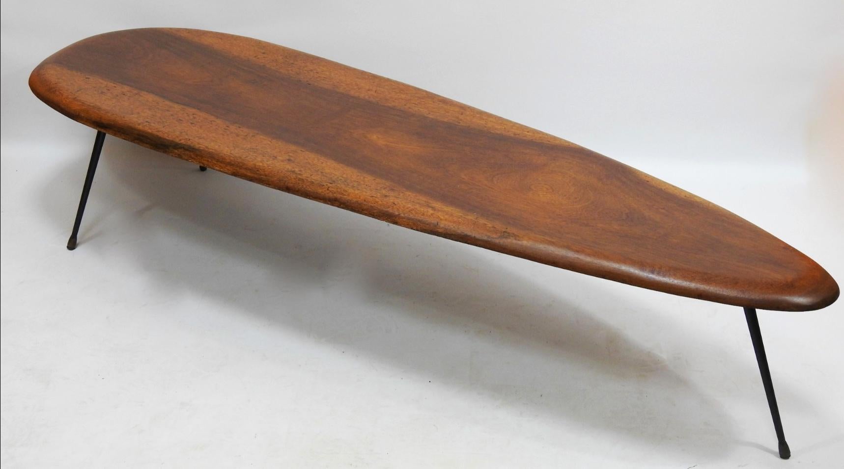 Oblong form for this anonyme coffee table from the 50's with wood top and 3 black metal feet.
