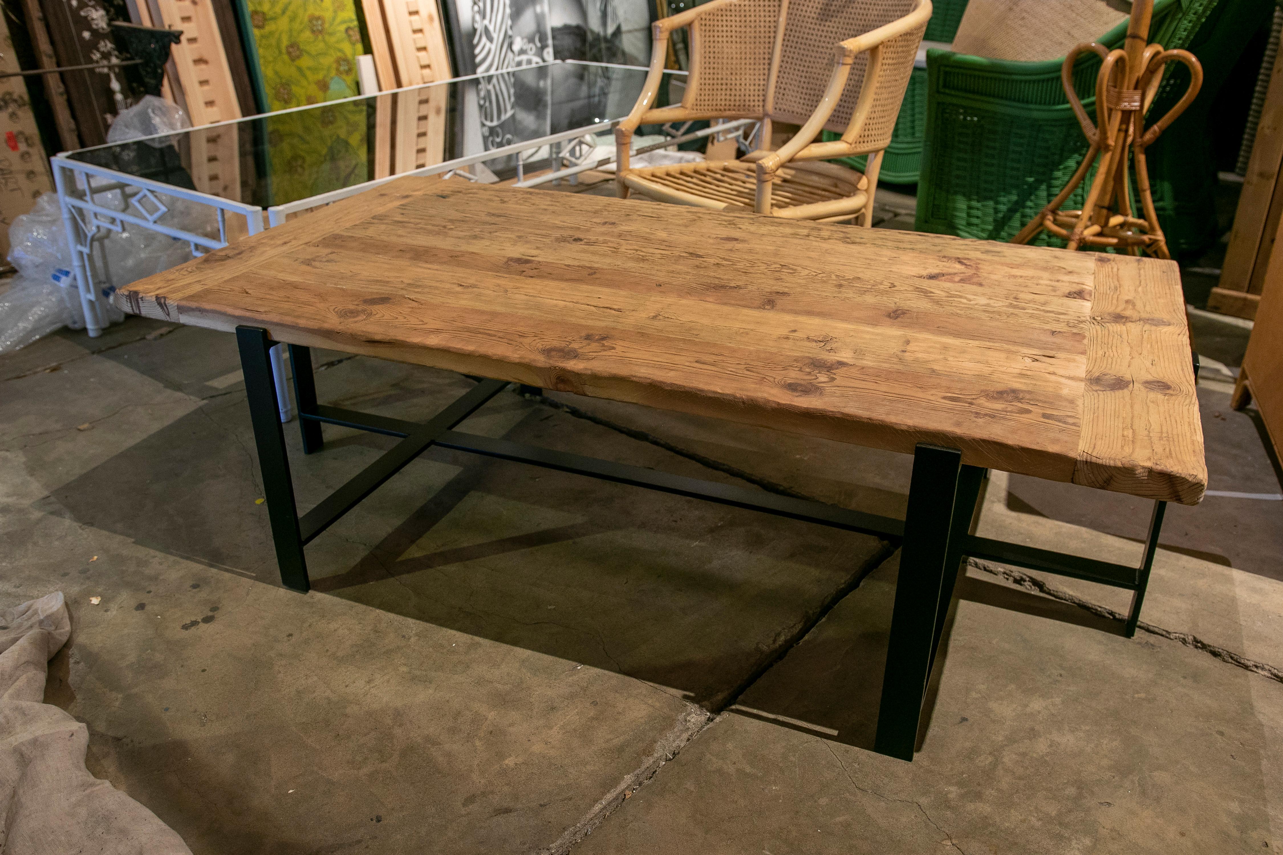 Coffee table with wooden top and iron feet.