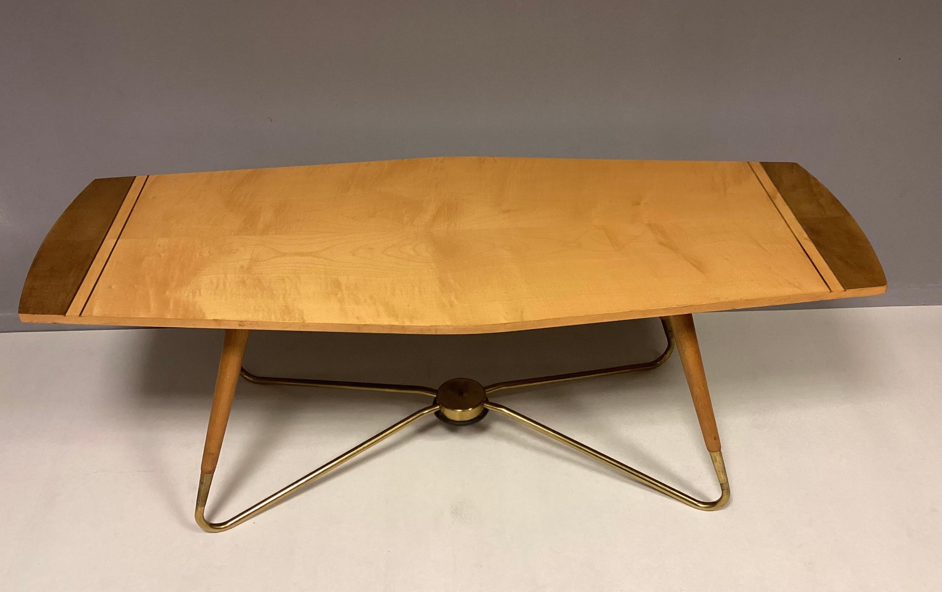 Sehr seltener und schöner Kaffeetisch aus den 50er Jahren von Ilse Möbel. 
Die Tabelle Schleife Füße und Platte hat eine sehr schöne Form. In Kombination von Holz und Messing. Auf der Unterseite befindet sich ein Stempel des Herstellers.
Der Tisch