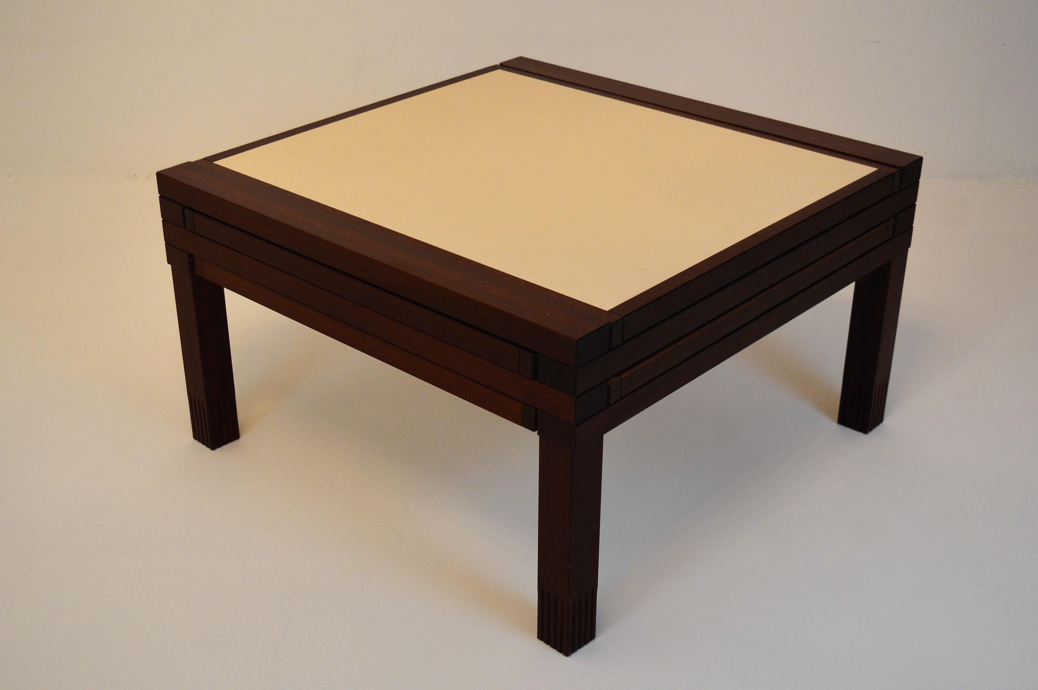 Very exceptional, first edition coffee table by Bernard Vuarnesson (Sweden) for Bellato in Italy, 1980s.
This table in solid Iroko-wood has four reversible laminated tops/drawers: 3 in red and white and one in black and white, which can be