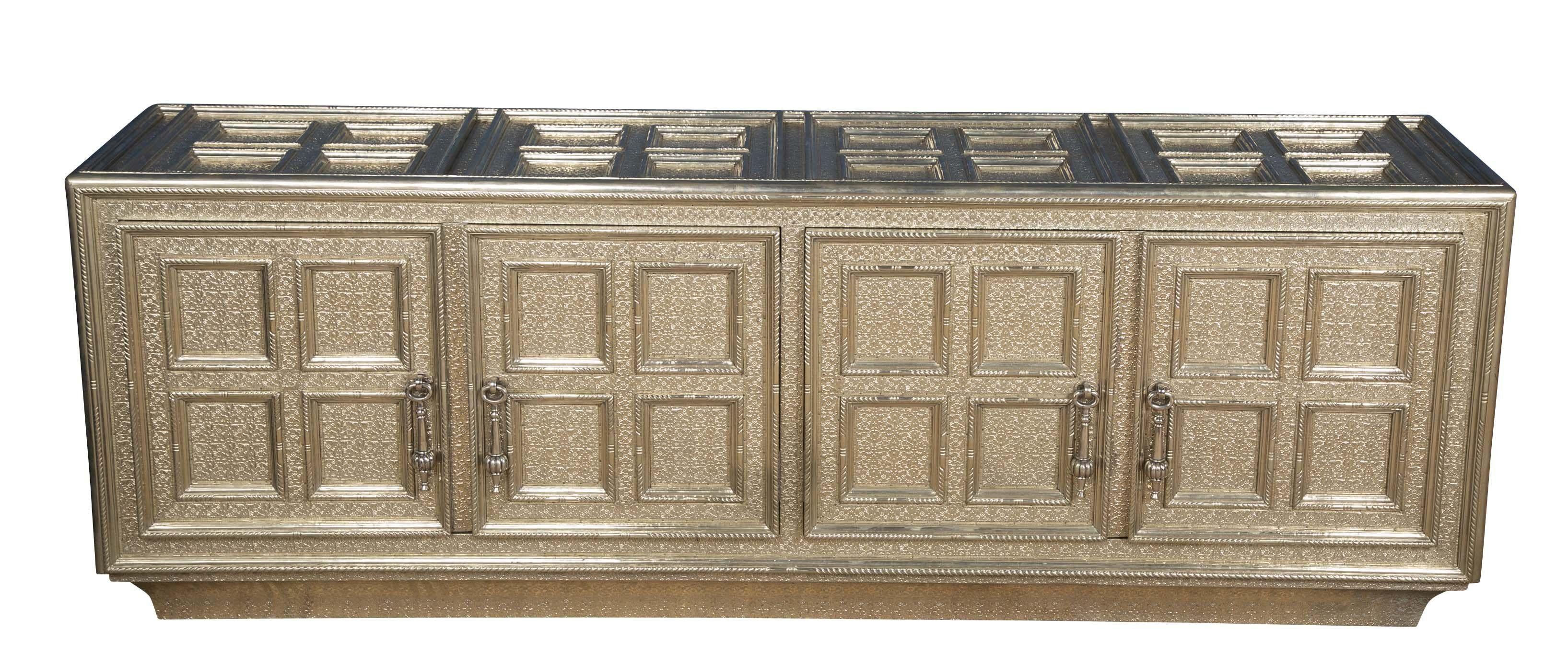 Inspired by the Classic coffered, hand-tooled metal-clad furniture of the opulent Mughal period. This elegant furniture is handmade from MDF that are joined into a repeating pattern of panels enclosed by raised moldings. Pattern makers then trace