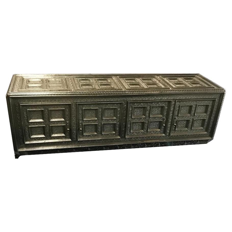 Inspired by the Classic coffered, hand-tooled metal-clad furniture of the opulent Mughal period. This elegant furniture is handmade from MDF that are joined into a repeating pattern of panels enclosed by raised moldings. Pattern makers then trace