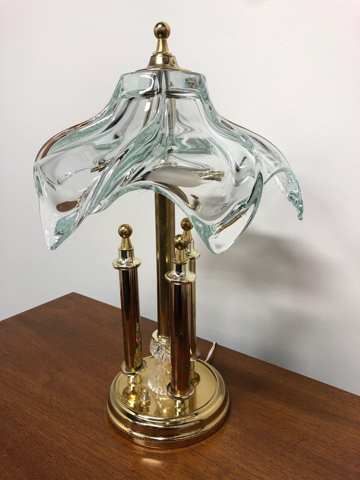 An Art Deco style table or desk lamp in brass and blown crystal. Presumed to be Cofrac Art Verrier from France. This piece is not signed; Cofrac used labels to identify their pieces which were usually removed by the purchasers for aesthetics. From
