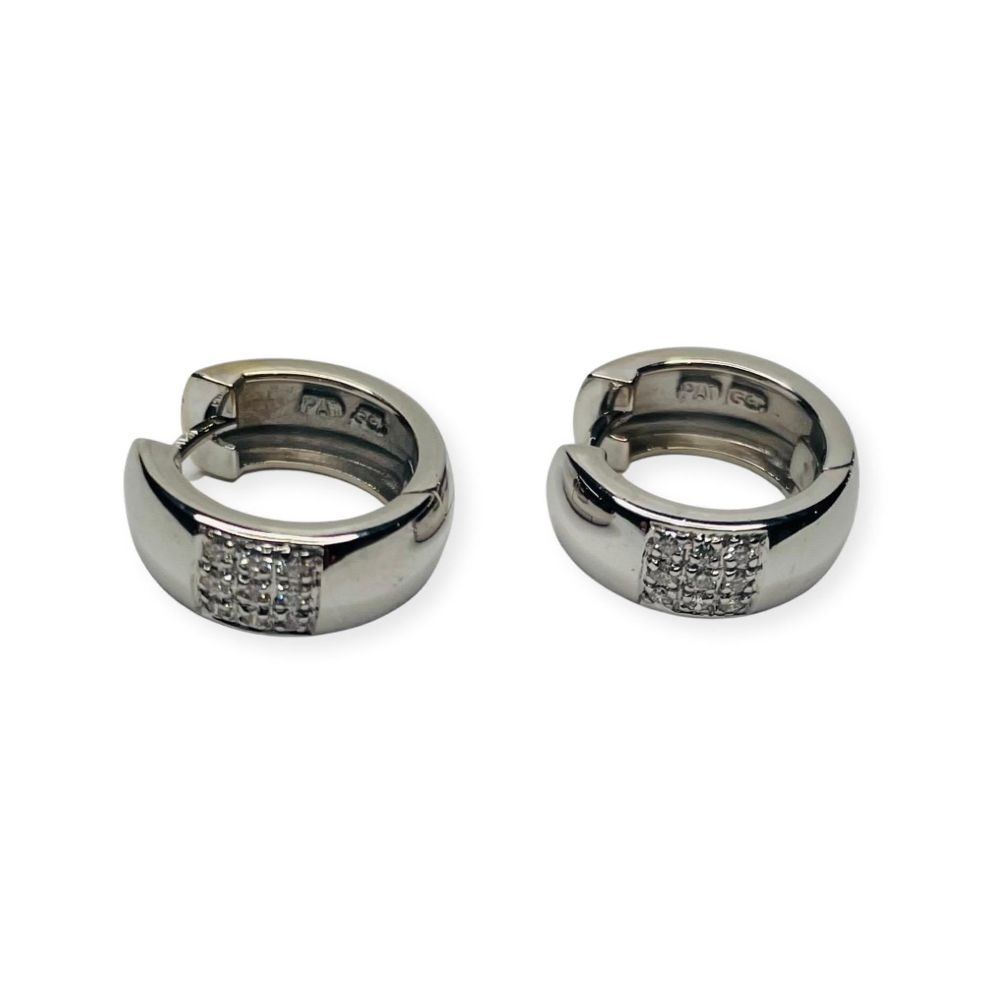Coge 18K White Gold Diamond Huggie Earrings. The earrings are 15.68 mm in diameter and 5.77 mm in width. There are 9, full cut round brilliant diamonds of VS clarity and F color. They are pave set in a three row square in the front of each huggie.