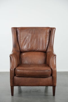 Cognac brown cow leather armchair with decorative nail finish