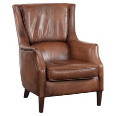 Cognac brown cow leather armchair with decorative nail finish
