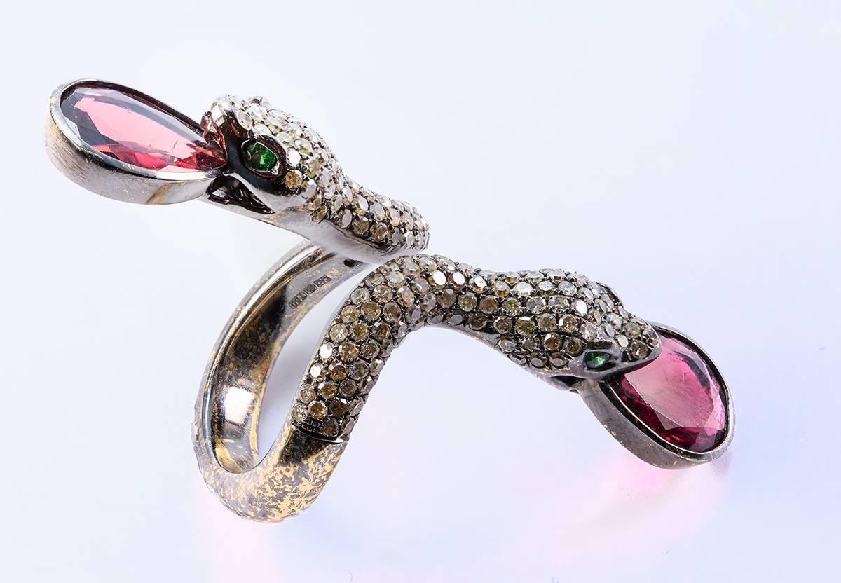 An Elegant Cognac Brown Pavé Diamond Double Snake Ring in 18 Karat Oxidized Gold featuring 2 Pear Shape Red Tourmalines 4.75 Carat Together. The Total Weight of the Brilliant Cut Brown Diamonds is 2.07 Carat SI Clarity. The eyes of the Snakes are