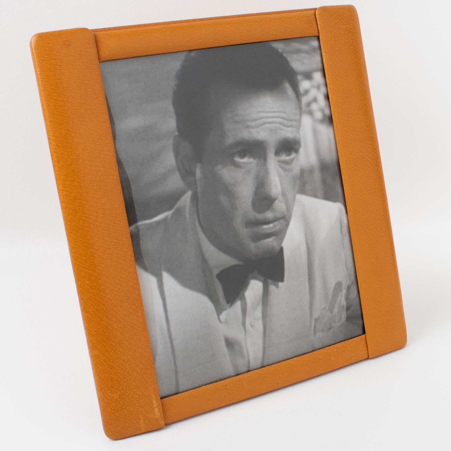 This stunning 1940s French Art Deco modernist leather picture photo frame features fine-grain calf leather in cognac color with a pattern. The easel and back are in the same calf leather, and a rhodoid protection is on the front to secure the