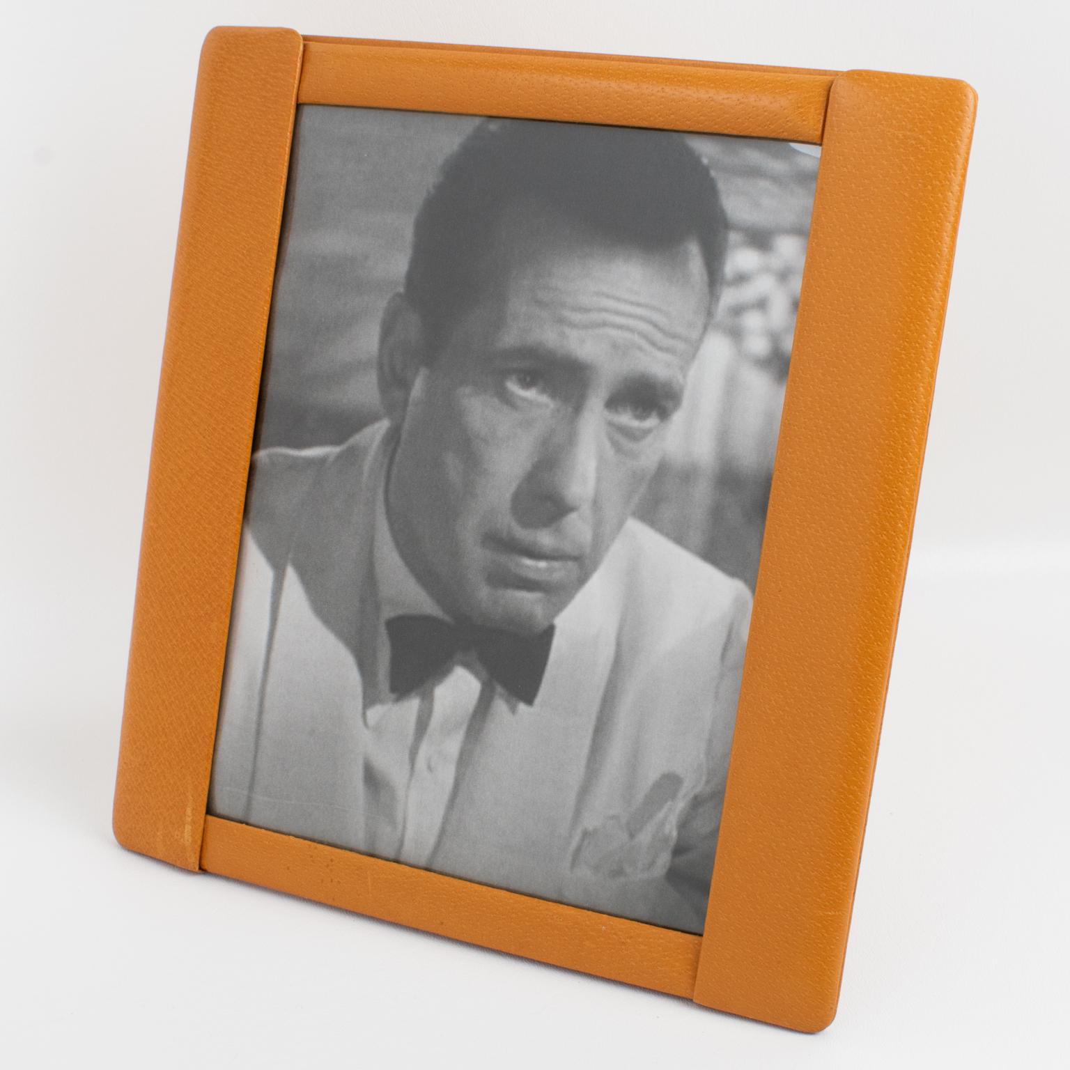 This stunning 1940s French Art Deco modernist leather picture photo frame features fine-grain calf leather in cognac color with a pattern. The easel and back are in the same calf leather, and a rhodoid protection is on the front to secure the
