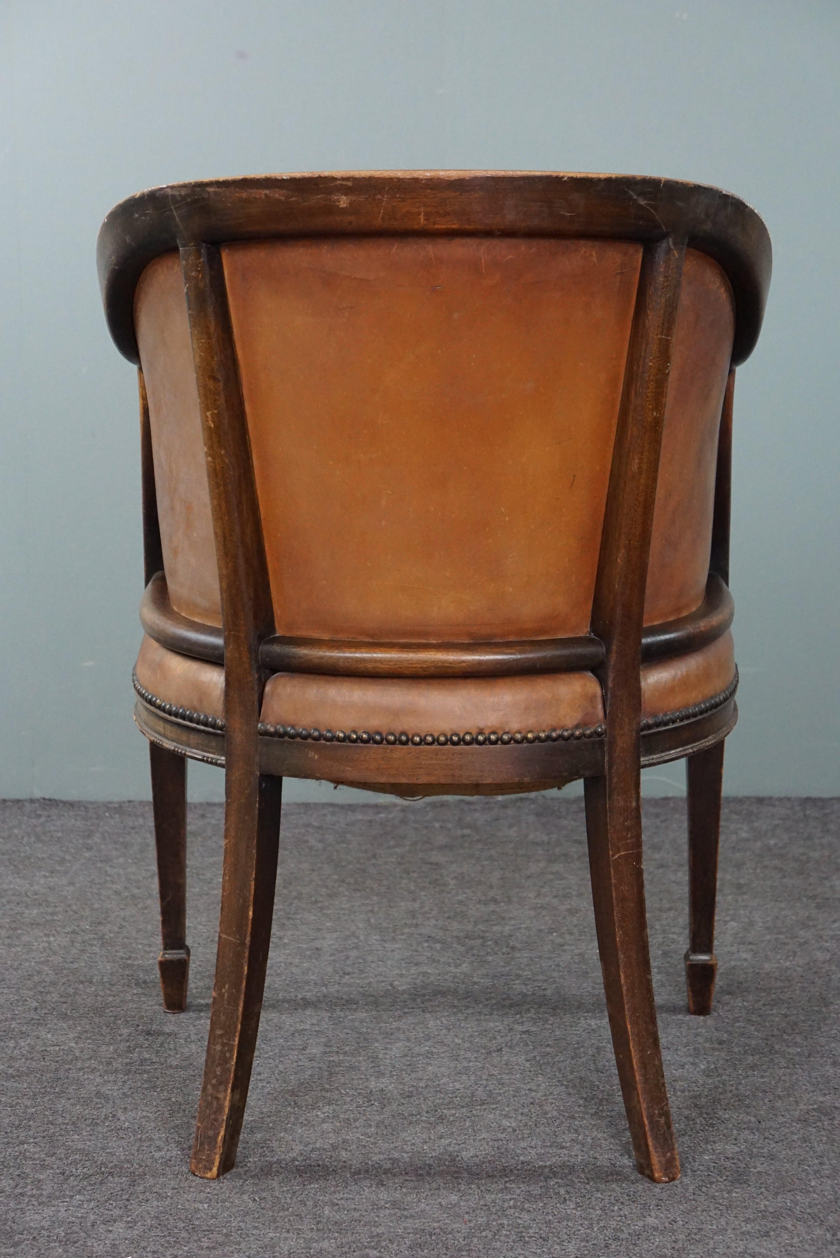 Leather Cognac-colored antique leather tub chair with beautiful patina For Sale