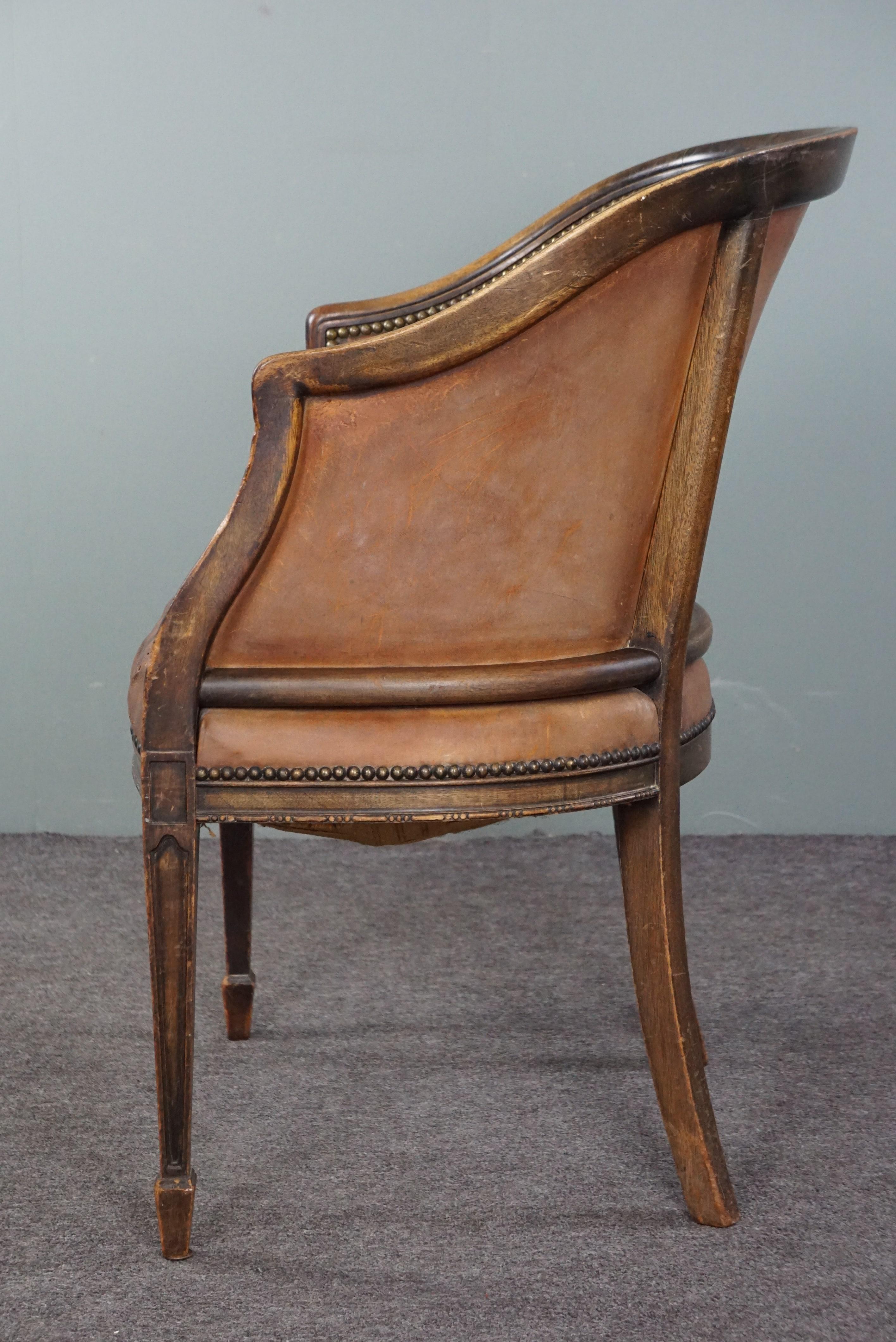Cognac-colored antique leather tub chair with beautiful patina For Sale 1