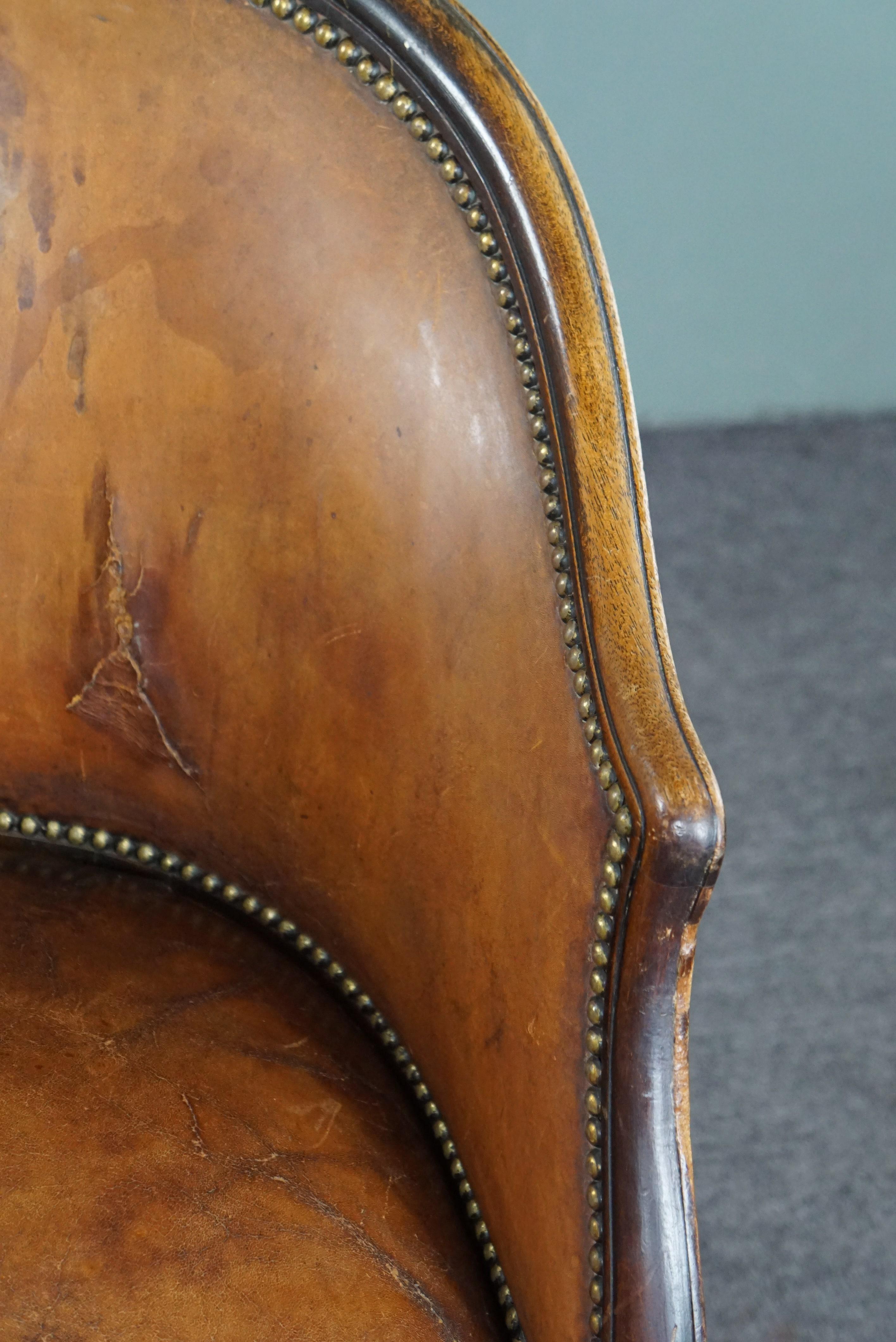 Cognac-colored antique leather tub chair with beautiful patina For Sale 4