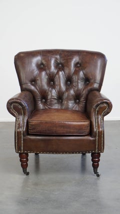 Cognac colored brown grained cowhide chesterfield armchair