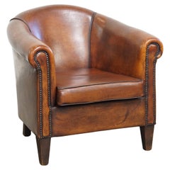 Fauteuil club en cuir de mouton de couleur cognac