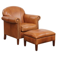 Poltrona e pouf in pelle di vacchetta color cognac