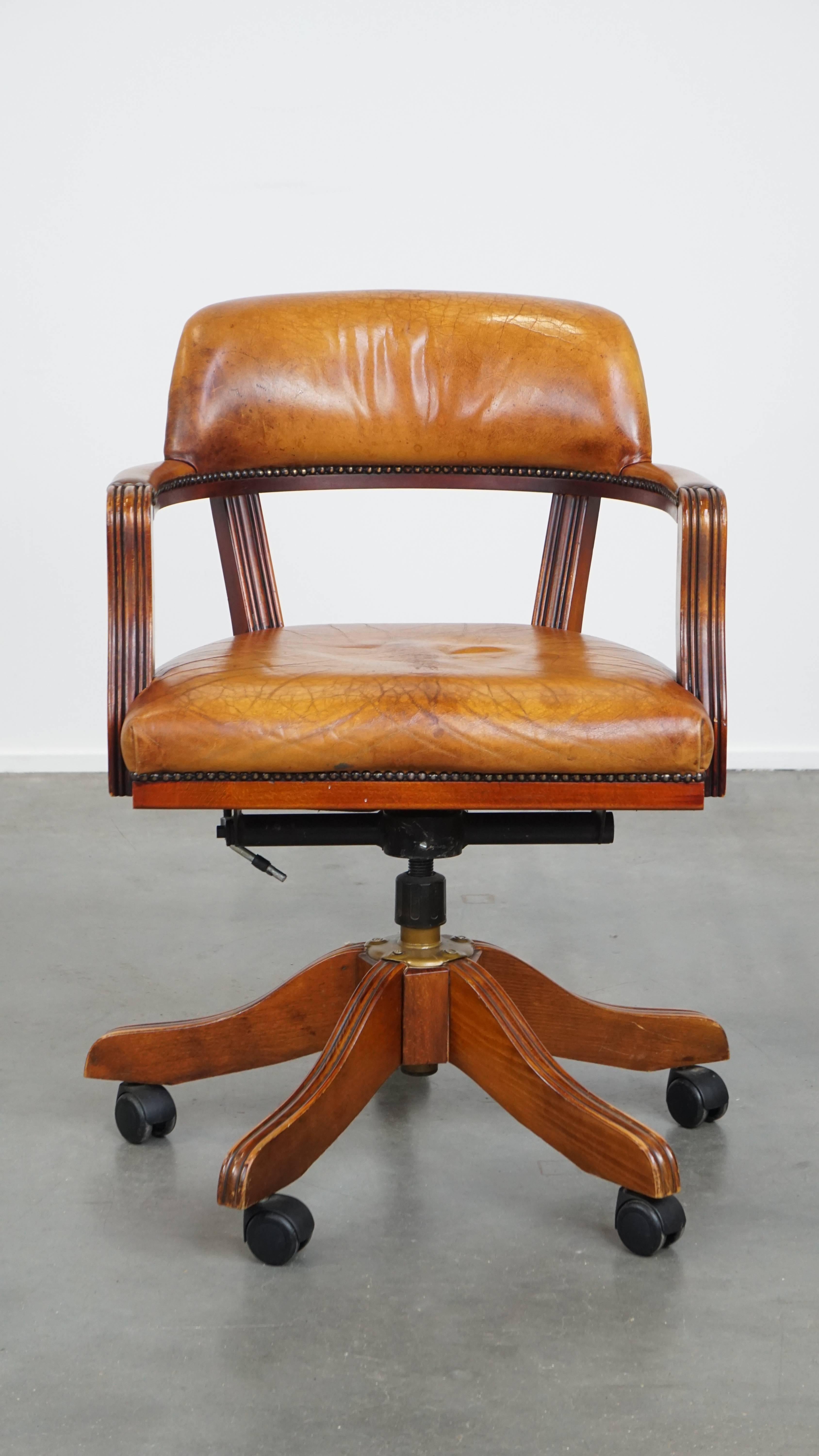 This office chair is crafted from cognac-colored cowhide leather and finished with decorative nailhead trim. Thanks to its timeless look, it fits effortlessly into almost any interior and room setting.

The chair swivels, is height adjustable, and