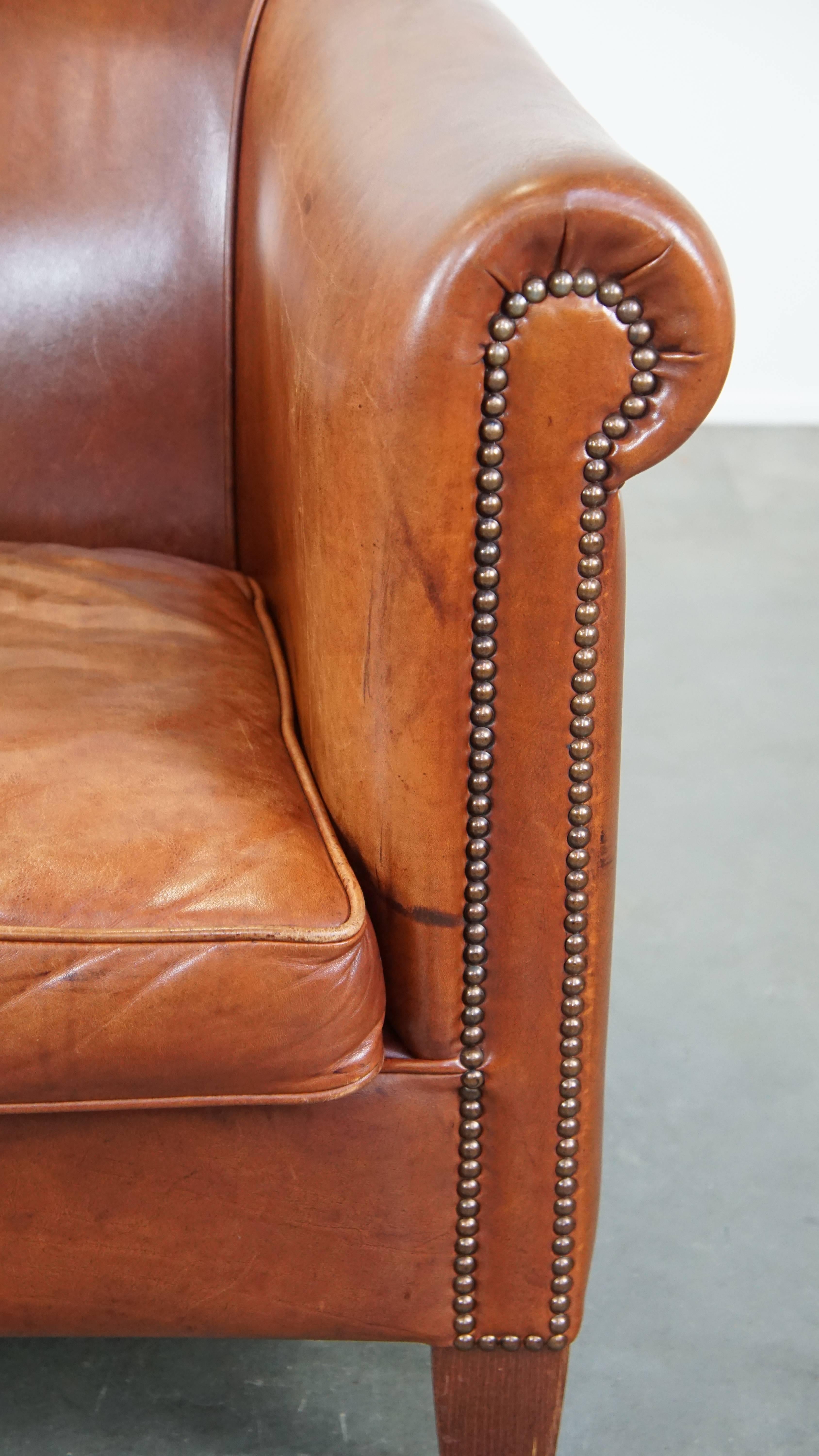 Cognac-colored English cow leather club chair finished with decorative nails For Sale 4