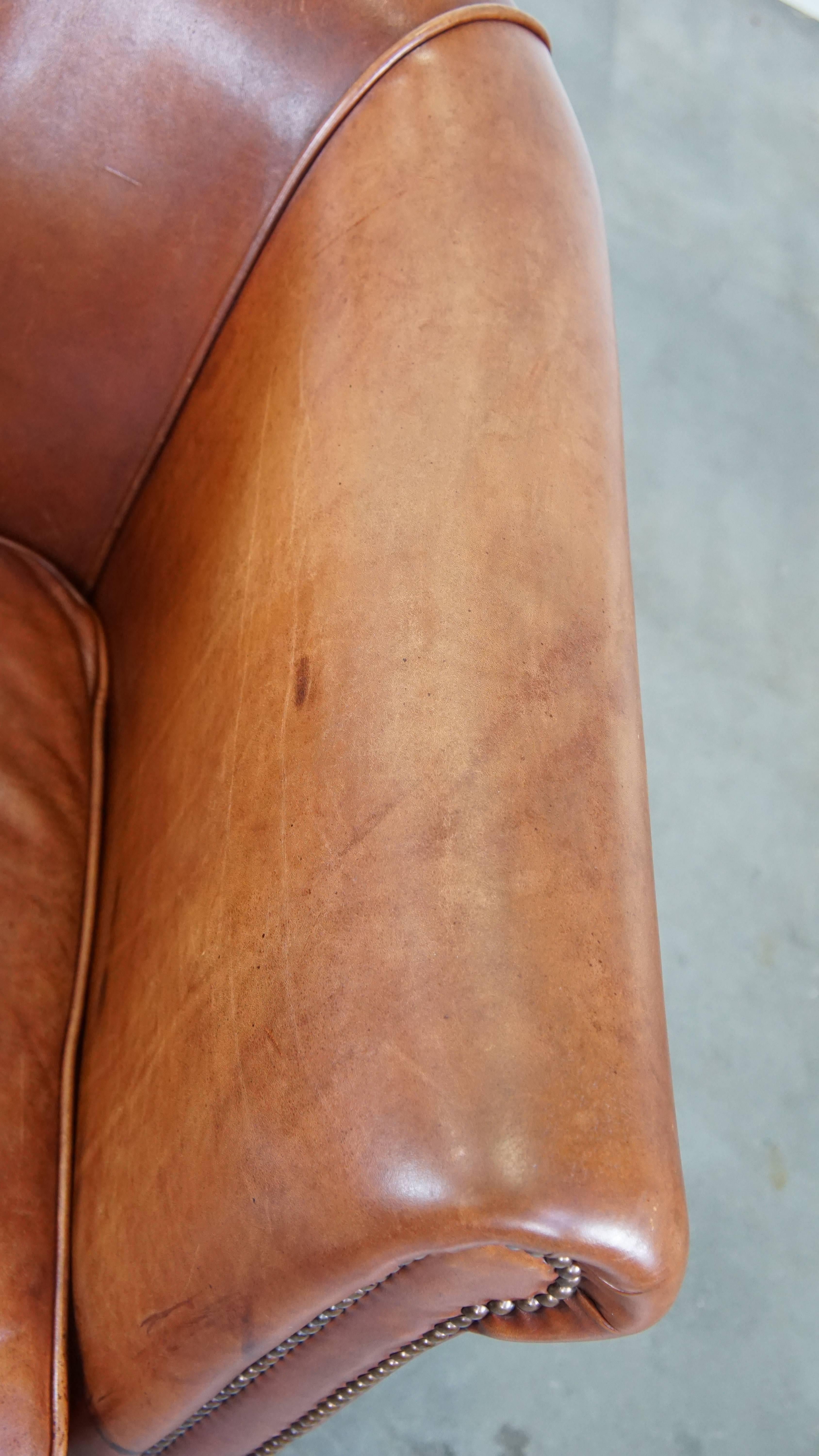 Cognac-colored English cow leather club chair finished with decorative nails For Sale 2