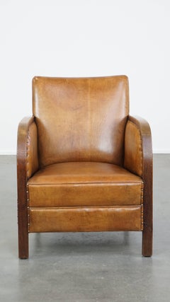 Cognac-colored sheepskin Art Deco design armchair with decorative nails