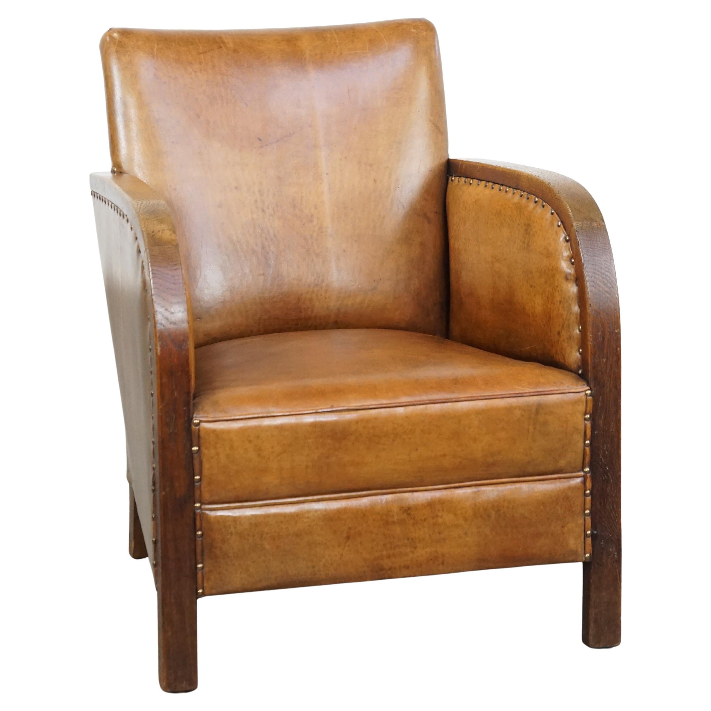 Cognac-colored sheepskin Art Deco design armchair with decorative nails