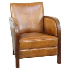 Cognac-colored sheepskin Art Deco design armchair with decorative nails