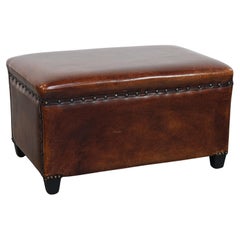 Cognac-colored sheepskin stool with decorative studs