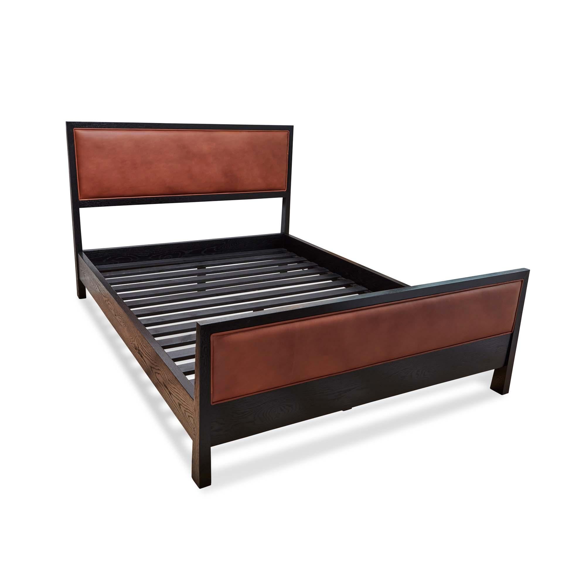 The Auden bed is a solid wood framed bed that can be made in either American walnut or white oak. The piece features an upholstered headboard and footboard. Slats are provided. Shown here in cognac leather and in ebonized oak. Queen size. 

The