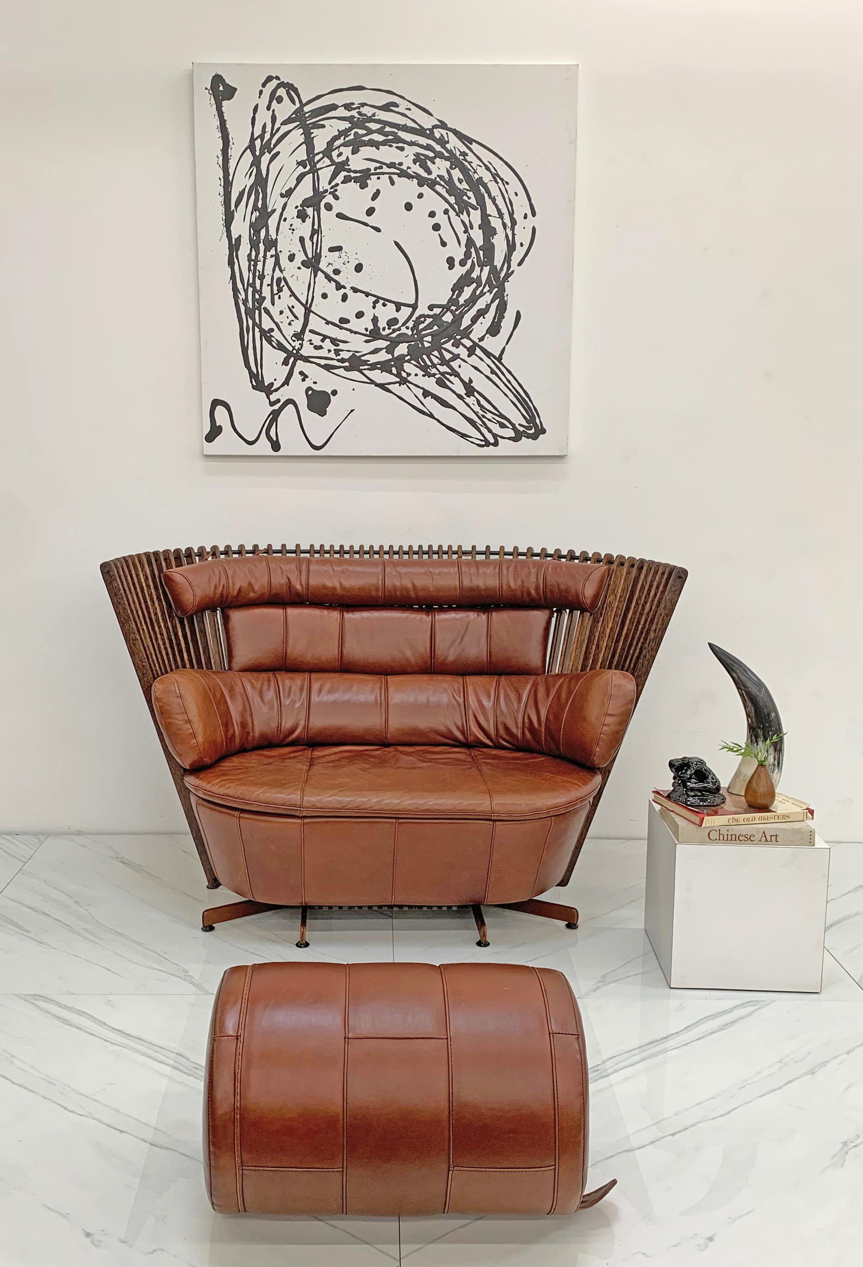 This sofa / settee is absolutely stunning. This 2 seater sofa consists of a gorgeous patinated cognac leather with polished palmwood fan-back frame. The attention to detail is just incredible-- even the bottom base of the sofa is completely clad in
