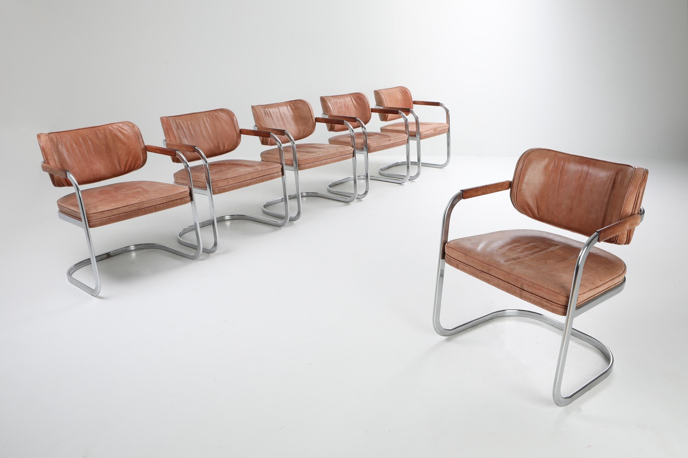 Mid-Century Modern chic set of armchairs in patinated leather and chrome by Walter Knoll, 1970s.

High quality armchairs in cognac leather which can be used as conference, dining or desk chairs.
Very modern minimalistic look in contrast with the