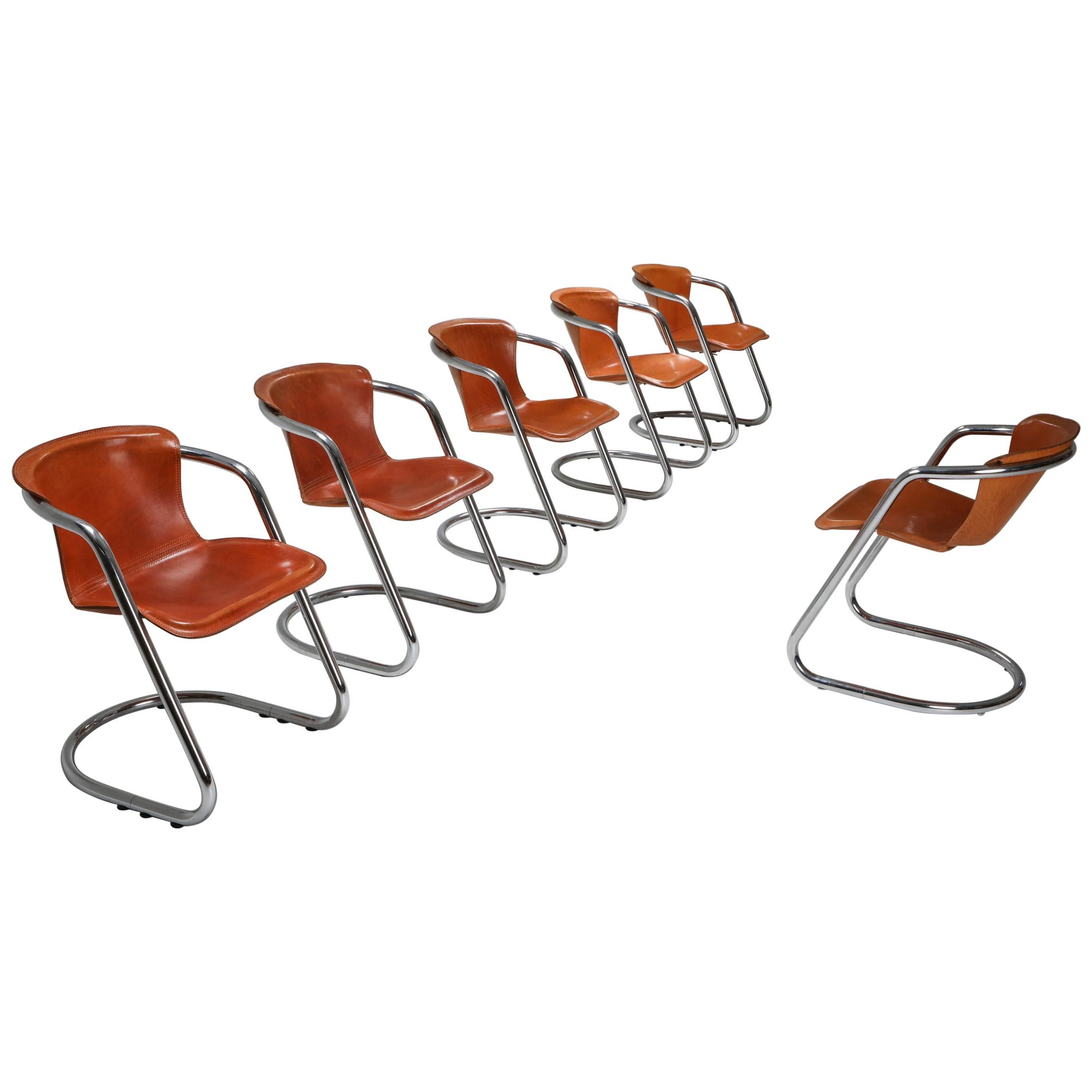 Willy Rizzo, Cidue, Italy, the 1970s, Cognac saddle leather dining chairs, superb set of armchairs by Willy Rizzo, a famous fashion photographer who became a furniture designer best known for its Italian glam style.
The tubular chrome frame and