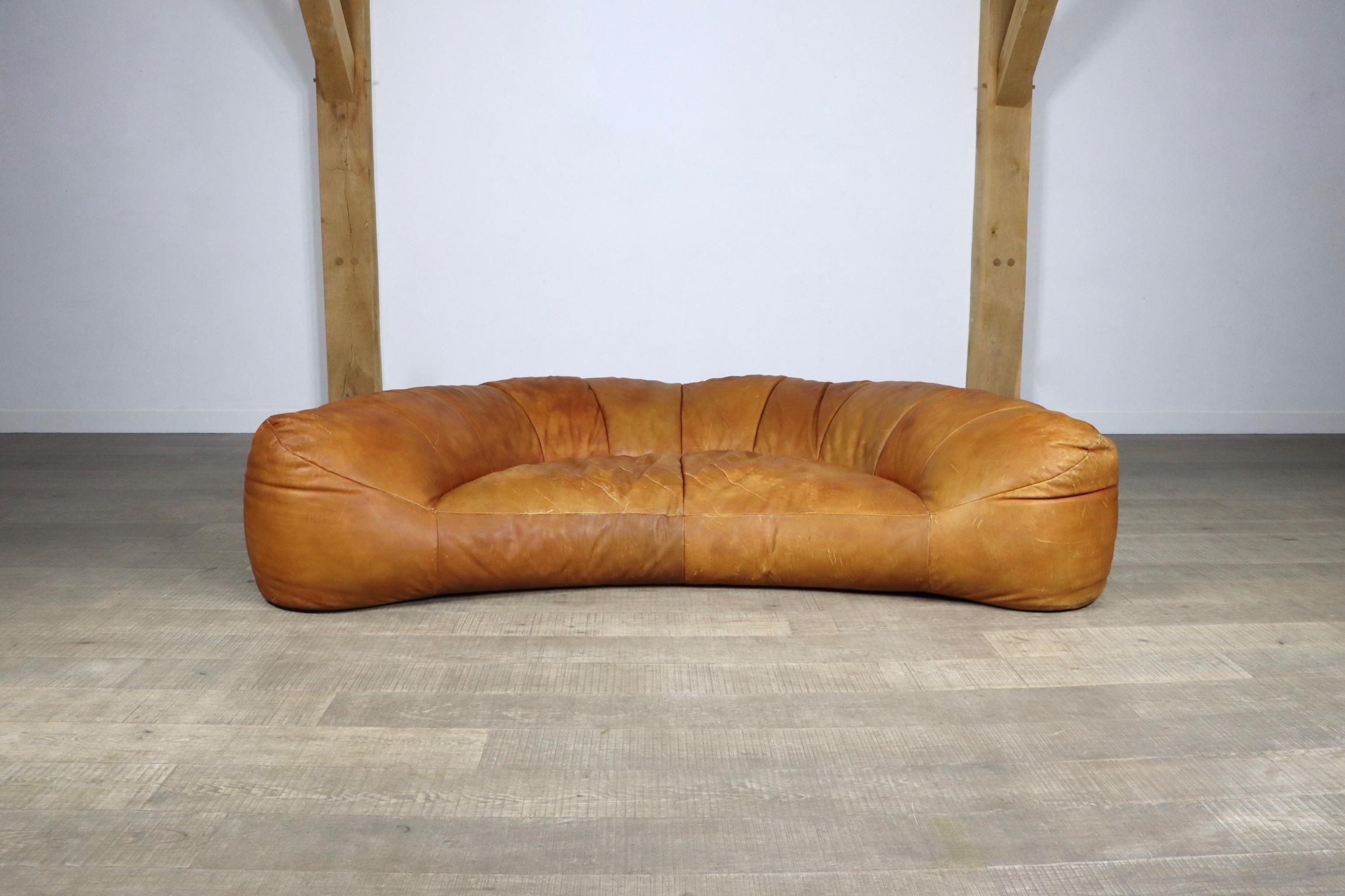 Incredible and rare croissant sofa in original cognac leather by Raphaël Raffel for Maison Honoré Paris, 1970s. This sofa, which was made to order from the 1970-1980s is besides its iconic design famous for its extremely high comfort. The stunning