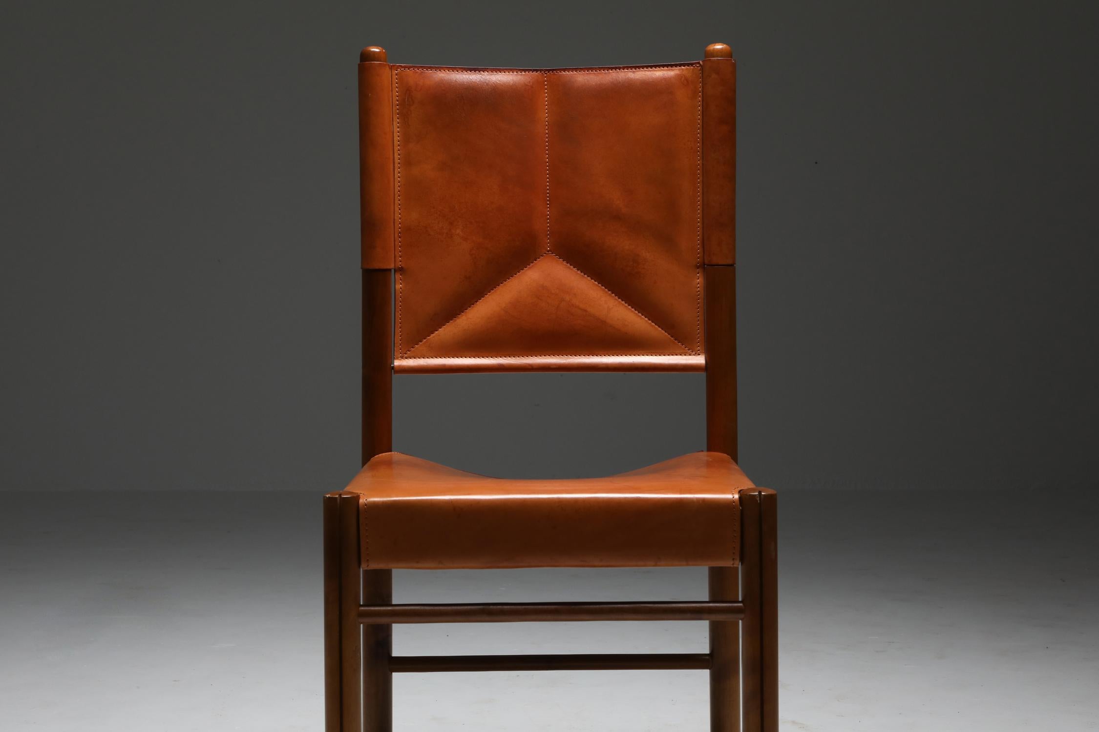 Cognac leather chairs, attributed to Carlo Scarpa, Italy, 1960s

Gorgeous set of four chairs, in beautifully aged natural saddle leather, and a solid walnut frame.
Produced in high end materials by possibly Maxalto or Bernini.
  