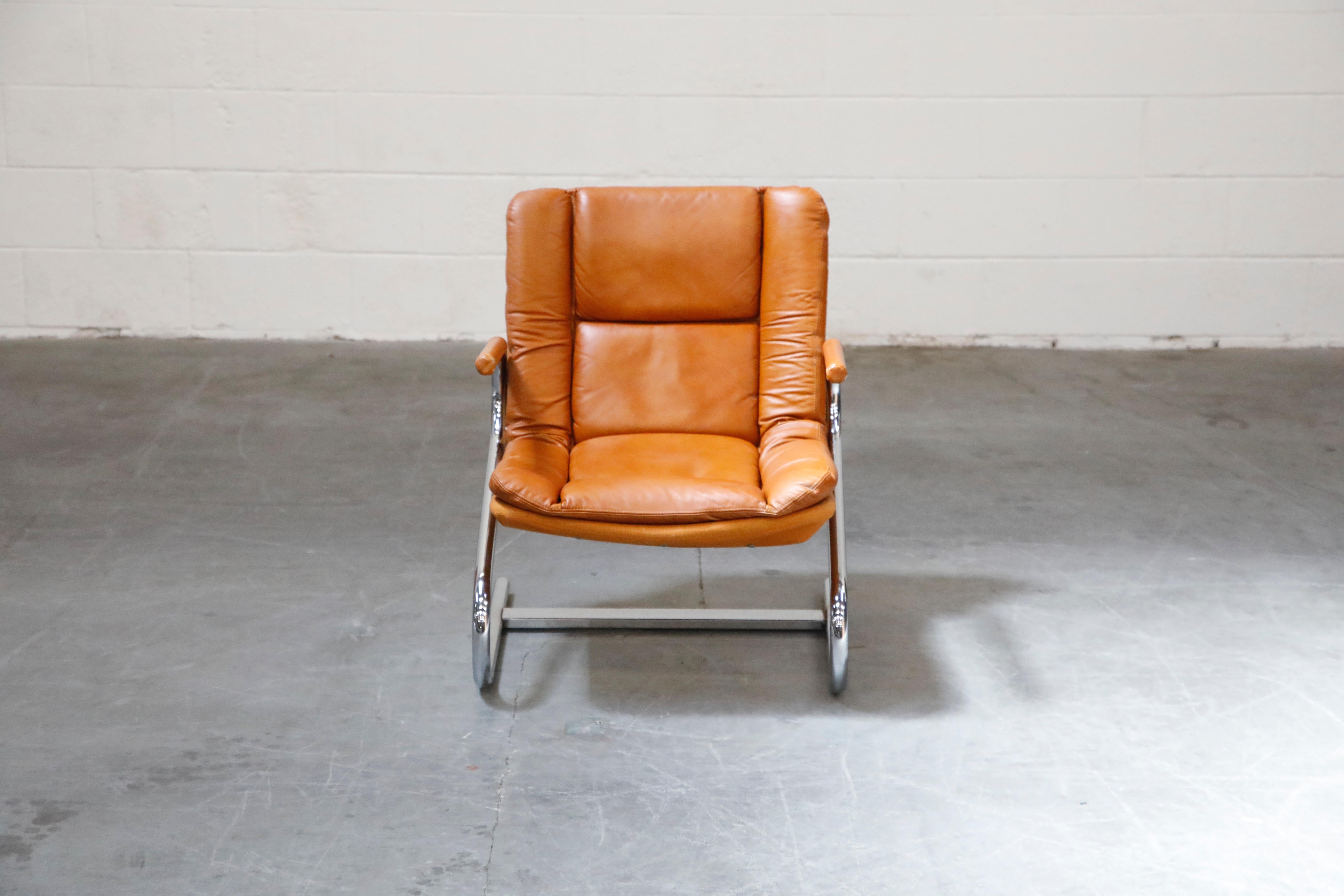 This stylish yet laid-back tubular lounge chair is attributed to Guido Faleschini for i4 Mariani for the Pace Collection. The seat and back retains its original lightly patinated cognac colored leather upholstery and are attached to graceful chromed