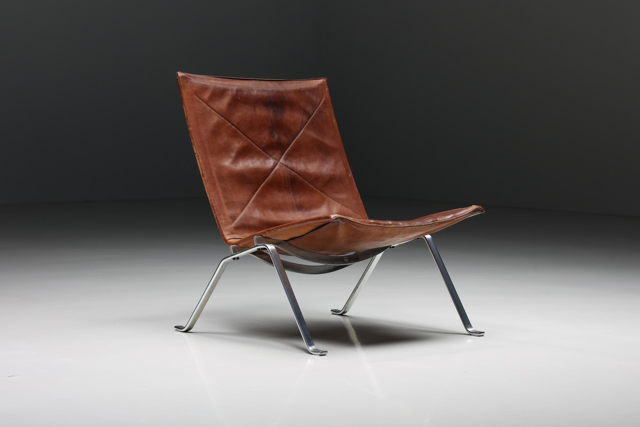 Cognac leather PK 22 Poul Kjaerholm lounge chair, Scandinavian Modern, 1960's

While his mid-century Danish peers were working with wood, Poul Kjærholm (1929–80) found inspiration in the structural potential of steel. His innovative PK22 chair,