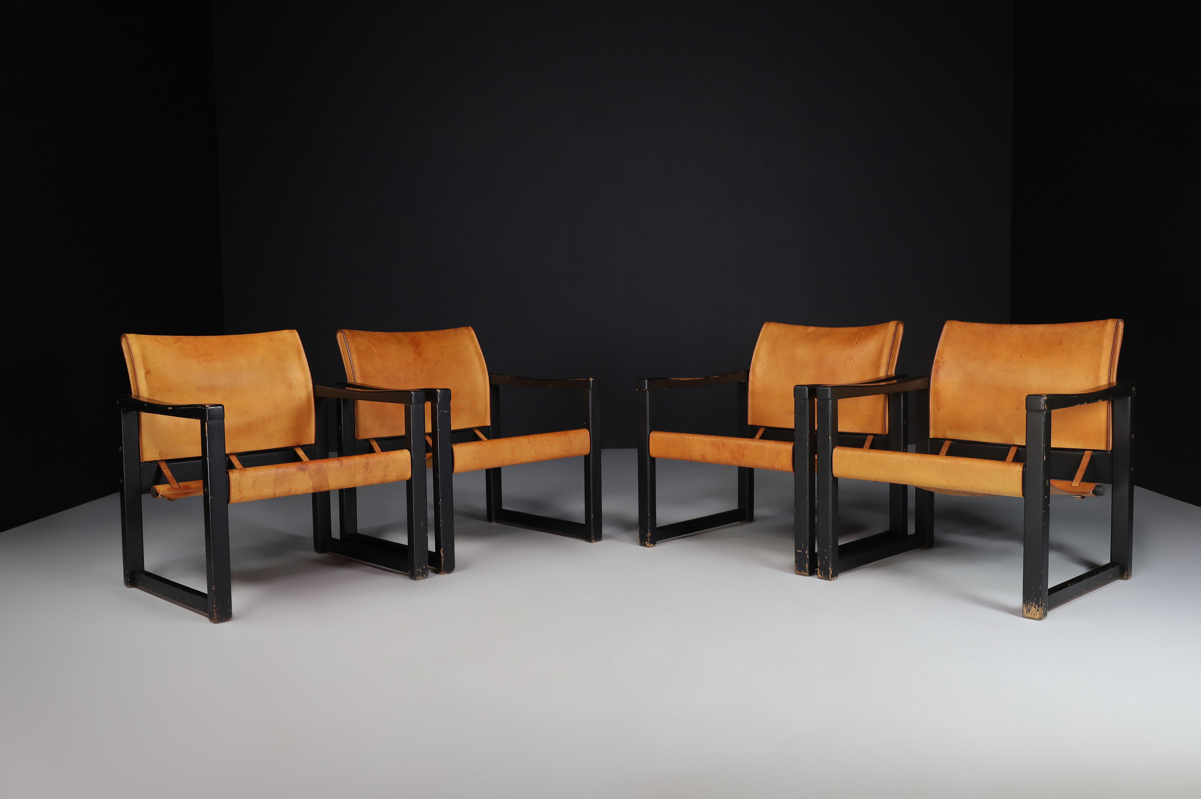 Cognac leather safari lounge chairs Karin Mobring, Sweden 1970s.

Karin Mobring designed this Ikea Classic Vintage Lounge chair in 1972. It is made of solid Scandinavian pine wood. This version is rare, black lacquered by the producer IKEA. The