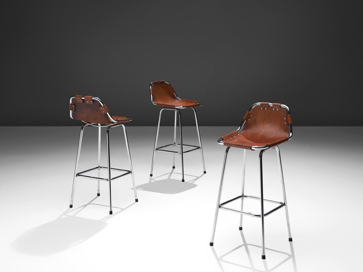 Set of three bar stools, in steel and leather by Charlotte Perriand, France, circa 1970s. 

Set of three stools of the famous model 'Les Arcs' by French architect and designer Charlotte Perriand. The simplistic design consist of a tubular steel
