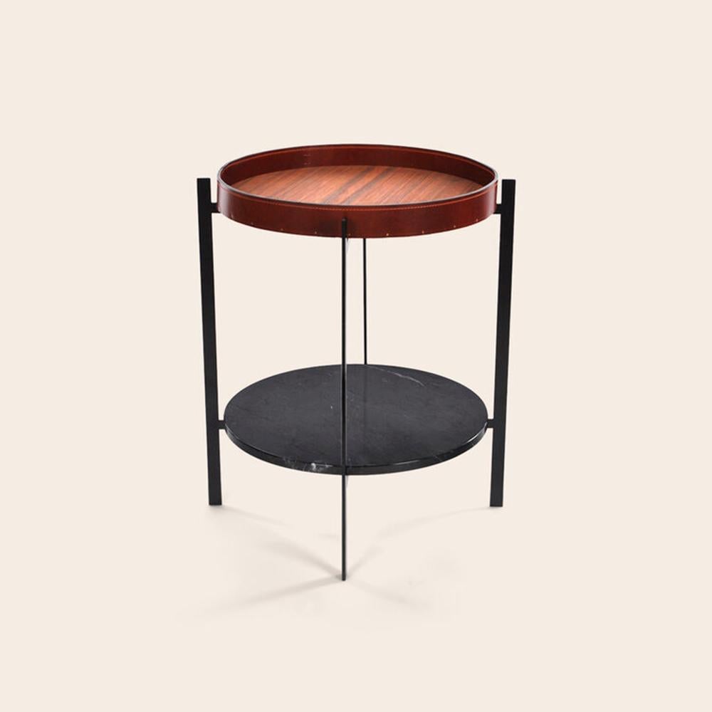 Cognac leather, teak wood and black Marquina marble deck table by OxDenmarq
Dimensions: D 57 x W 57 x H 67 cm
Materials: Steel, black Marquina marble, leather, teak wood
Also available: Different tray conbinations available

OX DENMARQ is a