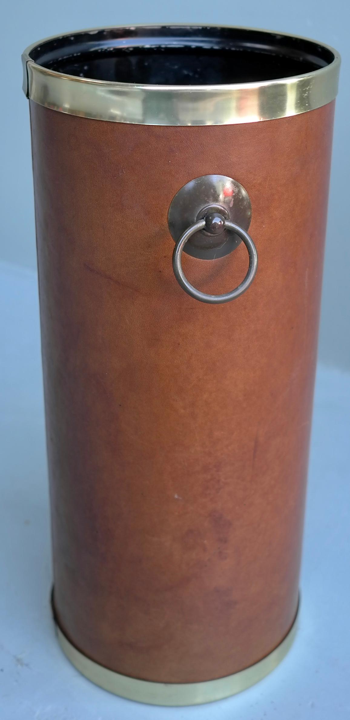 Cognac leather and brass umbrella stand, France, 1960s

With lovely patina to the cognac leather, with plastic rim and brass handles.